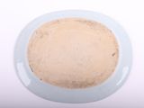 a white plate with a brown substance in it