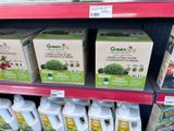 many bottles of greenjoy on the shelf in the store