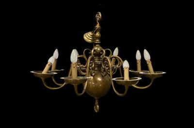 a gold chandelier with five lights hanging from it