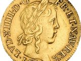 a close up of a gold coin with a woman ' s head on it
