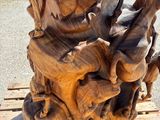 a wooden sculpture of elephants on a wooden table