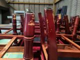 two red vases sitting on top of a wooden table