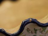 a blue and white bowl with a flower design on it