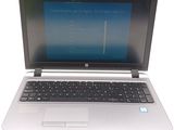 a laptop computer that is open on a white table