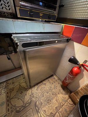 a fire extinguisher in the corner of a kitchen