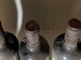 four bottles of wine are lined up in a row on a counter