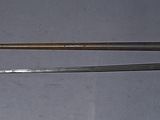 pair of old metal tools sitting on top of a gray surface