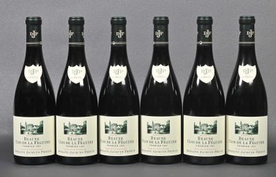 six bottles of wine are lined up in a row on a table