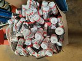 a box full of cans of glue and other items