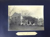 photograph of a black and white photo of a building with trees in front of it