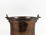 an old copper pot with handles on a white background
