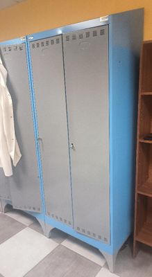 a blue cabinet with a coat rack in the corner of the room