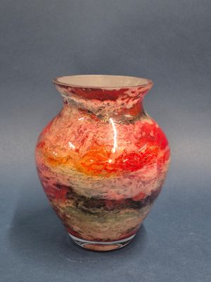 a vase with a red, yellow, and green design on it