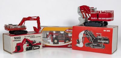 three toy trucks and a toy truck in a box