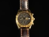 an image of a gold watch with a brown leather strap