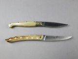 two knives that are sitting next to each other on a table