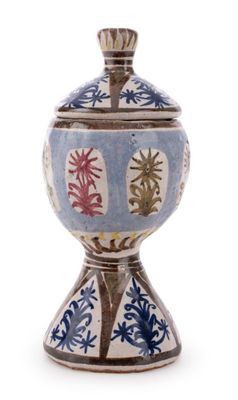 a blue and white vase with red flowers on it