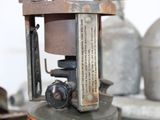 an old fashioned gas stove sitting on top of a table