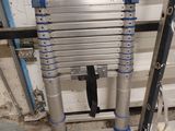 two ladders that are next to each other in a garage