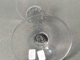 two empty wine glasses sitting next to each other on a table