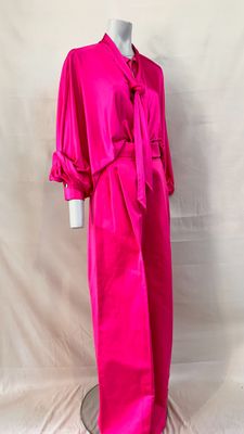 the dress is pink and has a tie on the waist