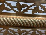 brass plate with a decorative design on it on a white surface