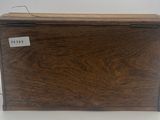 an old wooden chest with a label on it