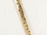 gold bracelet with hearts on it on a white surface