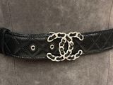 a close up of a black belt with a silver buckle