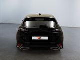 the rear end of a black car in a white room
