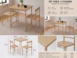a table and two chairs with a plant on top of it