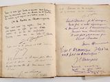 an open book with handwriting on it sitting on top of a table
