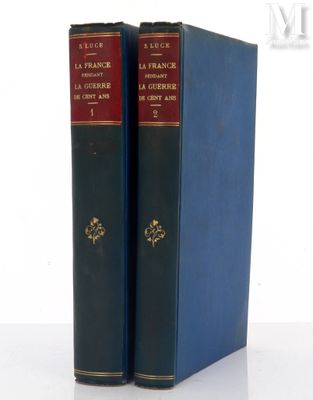 two blue books sitting on top of each other on top of a table