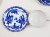 many plates and cups on the table with blue and white designs