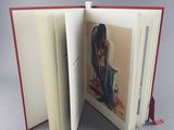 an open book with a picture of a woman on it