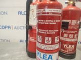 bottles of fire extinguisors are lined up on a counter