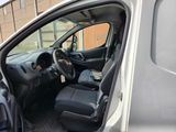 the interior of a van with the door open and the driver ' s seat down