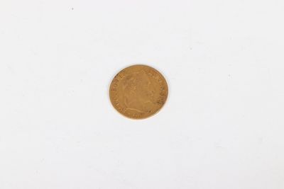 a close up of a gold coin on a white surface