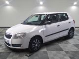 a picture of a small white car parked in a garage