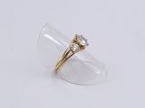 an image of a gold ring with a diamond on it