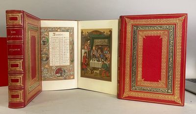 three books that are open on a table