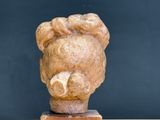 a statue of a woman ' s head on a wooden stand