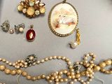 a lot of jewelry that is laying out on the table
