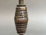a close up of a metal candle holder on a table