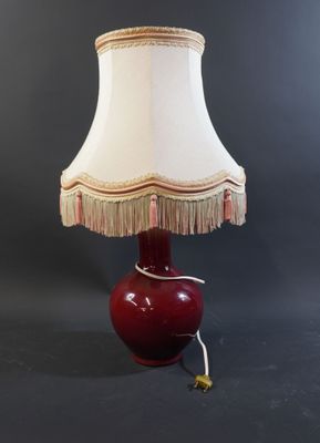 an image of a red lamp with a white shade on it