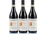 three bottles of red wine sitting next to each other on a white surface