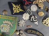 a lot of badges and other items on a table