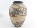 a vase with a picture of a farm and a barn on it
