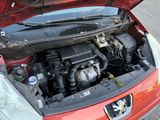 a red car with its hood open and the engine in the trunk
