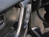 a close up of a car door handle with a button